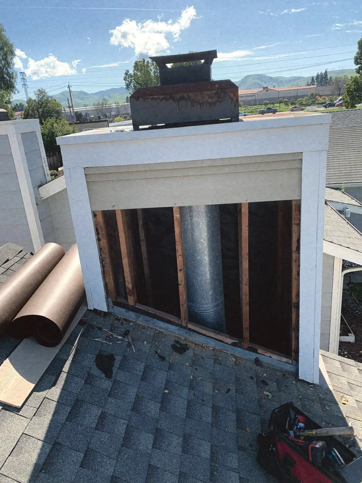 An open chimney chase showing the metal flue pipe inside