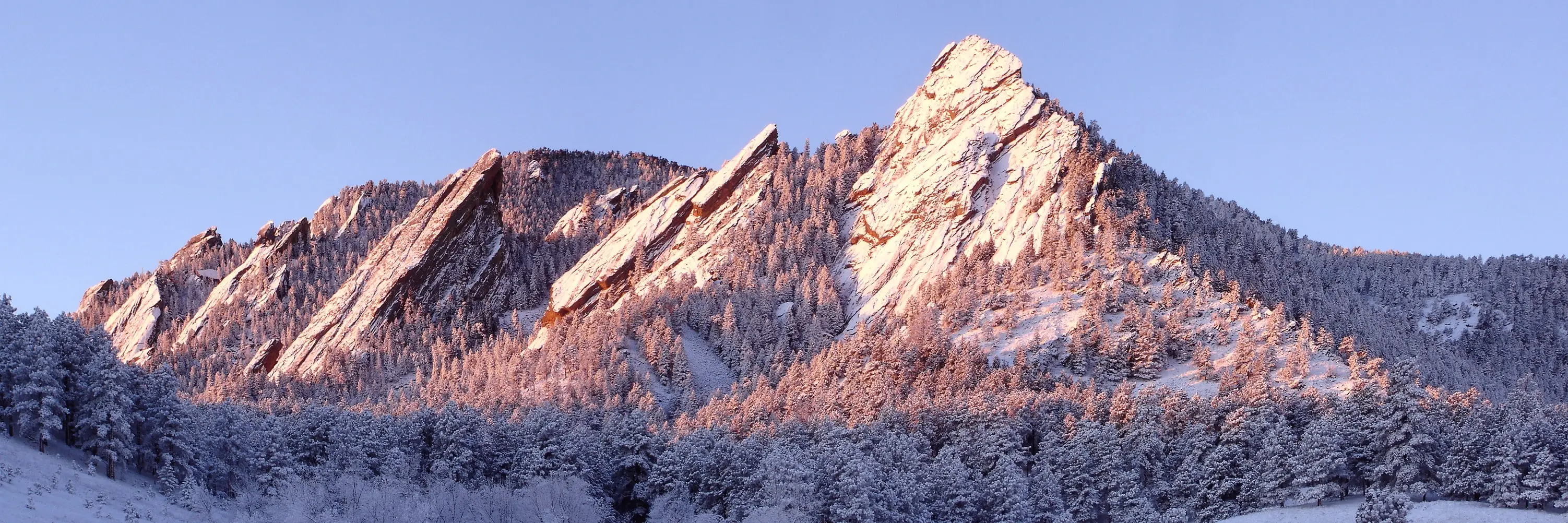 The Flatirons above Boulder at sunrise, covered in fresh snow